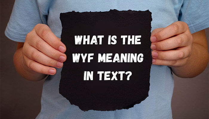 Person holding sign asking What is the WYF meaning in text?