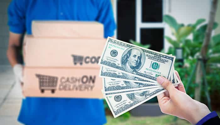 A person holding cash in hand for cash on delivery, with a package in the background, showing the payment method for SHEIN orders.
