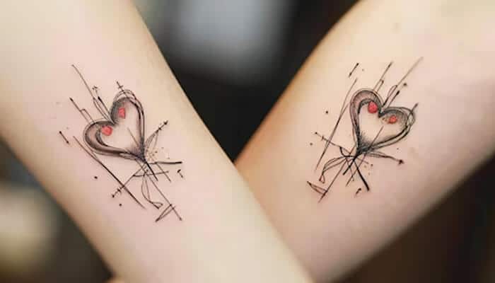 Cute Couple Tattoo Ideas - Fashion in beauty - Fashion in Beauty Creative couple tattoo ideas featuring abstract heart designs on arms, symbolizing love and togetherness.