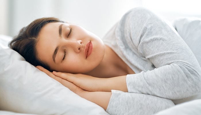 Get Proper Sleep - Fashion in beauty - Fashion in Beauty How to get clear skin: Woman sleeping peacefully in bed, following a healthy sleep routine for glowing and rejuvenated skin.