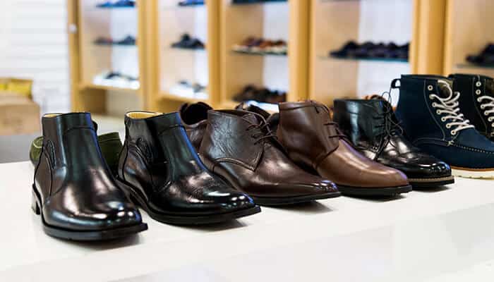 Types of boots every man should know - Fashion in beauty - Fashion in Beauty Best Boots For Men: A selection of fashionable men's boots in different styles, including black leather, brown leather, and casual boots, neatly arranged on a display table.