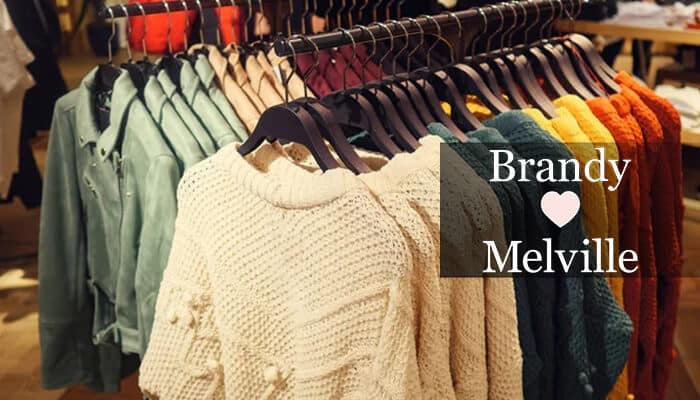 Brandy Melville - Fashion in beauty - Fashion in Beauty Gen Z fashion brands: A display of trendy sweaters in a Brandy Melville store showcasing a variety of colors and styles for young adults.
