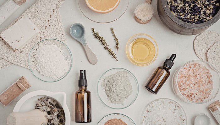 DIY Natural Dish Soap - Fashion in beauty - Fashion in Beauty Natural ingredients like herbs, oils, and clays arranged on a surface, showcasing the pure, plant-based components often used in eco-friendly dish soaps.