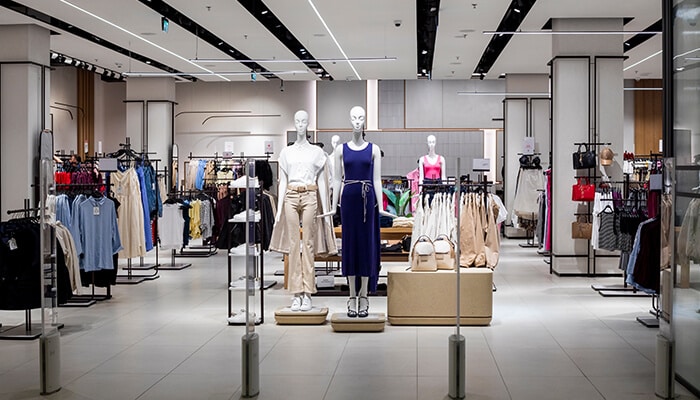 Impact on Mall Fashion Brands - Fashion in beauty - Fashion in Beauty Shein, Temu Impact US Retail: Modern retail store interior with mannequins showcasing fashion items, highlighting the shift in mall fashion due to ultra-fast fashion brands like Shein and Temu.