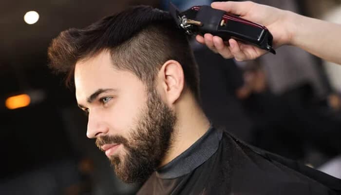 Low taper fade with straight hair - Fashion in beauty - Fashion in Beauty Low Taper Fade with straight hair featuring clean, gradually faded sides and a neatly styled straight top, showcasing a sharp and modern Low Taper Fade haircut during a professional barber trim.