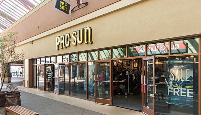 PacSun - Fashion in beauty - Fashion in Beauty Gen Z fashion brands: A PacSun store featuring the latest fashion trends for Gen Z, with large glass doors displaying the store's merchandise and sale promotions.