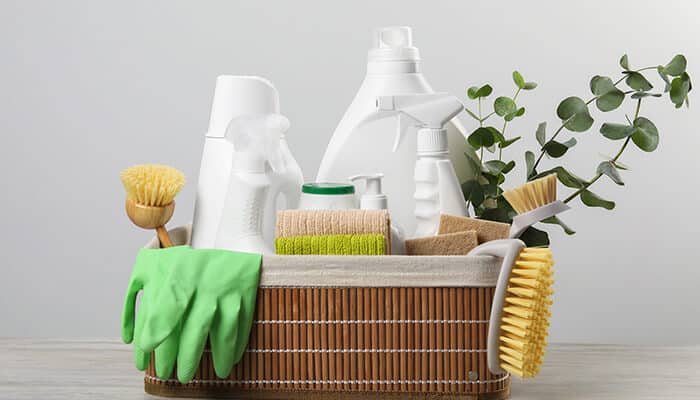 Top Benefits of Using Natural Dish Soap - Fashion in beauty - Fashion in Beauty Various cleaning supplies arranged in a basket, including plant-based dish soap, eco-friendly sponges, green gloves, and natural cleaning products, highlighting the advantages of using natural dish soap.