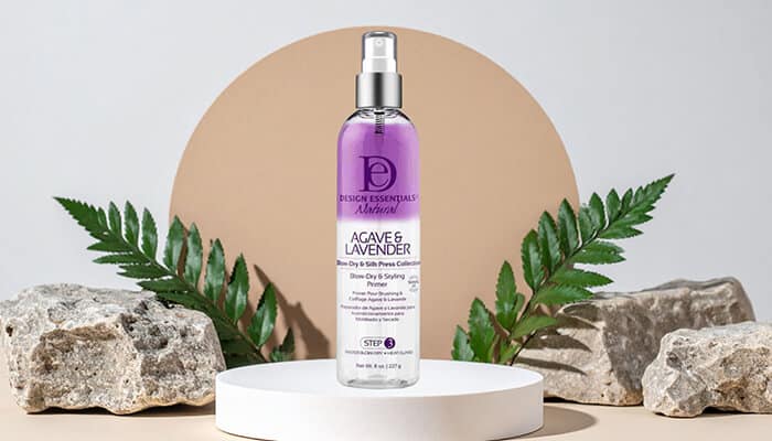 Design Essentials Agave Lavender Blow-Dry Heat Shield - Fashion in beauty - Fashion in Beauty Agave & Lavender hair spray presented on a pedestal with natural elements, formulated for smooth styling and heat defense, making it a Best Heat Protectant Spray choice.