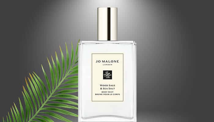 Jo Malone London Wood Sage Sea Salt - Fashion in beauty - Fashion in Beauty Best Fragrances displaying Jo Malone Wood Sage and Sea Salt perfume bottle with tropical leaf background.