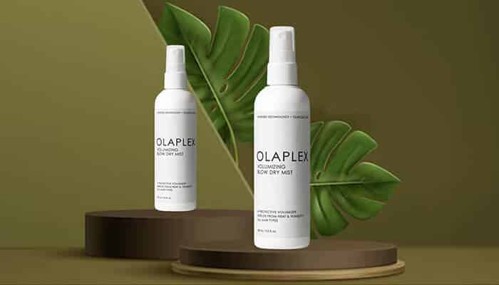 Olaplex Volumizing Blow Dry Mist - Fashion in Beauty - Fashion in Beauty Olaplex Volumizing Blow Dry Mist bottles styled with green leaves, strengthening hair bonds while offering thermal protection as a Best Heat Protectant Spray.