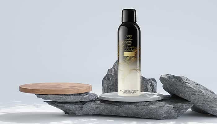 Oribe Gold Lust Dry Heat Protection Spray - Fashion in beauty - Fashion in Beauty Premium heat protectant spray displayed on stone textures, emphasizing thermal protection and hair nourishment as a Best Heat Protectant Spray for salon-level care.