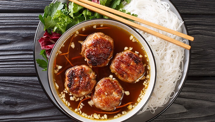 Bun Cha and Beyond - Fashion in beauty - Fashion in Beauty Traditional Vietnamese grilled meatballs served with vermicelli noodles and fresh herbs, showcasing authentic cuisine from Hanoi's Old Quarter.