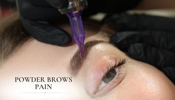 Powder Brows Pain - Fashion In Beauty - Fashion in Beauty Powder Brows vs Microblading comparison showing powder brows procedure in progress with a cosmetic tattoo machine applying pigment to the eyebrow area, highlighting the controlled vibration technique, minimal discomfort approach, and how powder brows differ from microblading in terms of application method, skin penetration depth, and perceived pain levels during semi-permanent eyebrow enhancement.