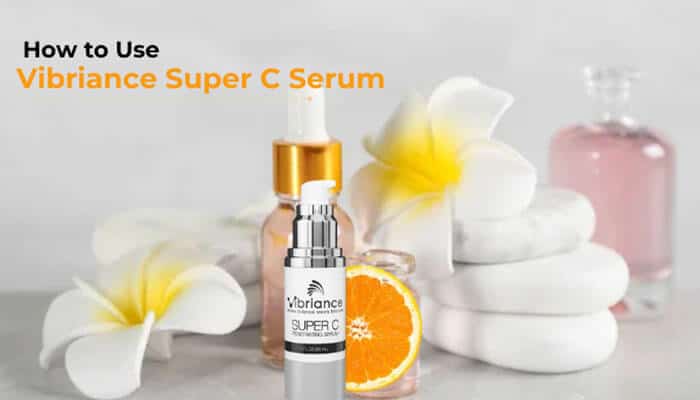How to Use Vibriance Super C Serum - Fashion In Beauty - Fashion in Beauty Vibriance Super C Serum displayed with orange and spa essentials, illustrating how to use the vitamin C and hyaluronic acid serum for brighter, hydrated skin.