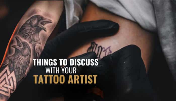 Things to Discuss With Your Tattoo Artist - Fashion In Beauty - Fashion in Beauty Small Nordic Raven Tattoo consultation showing a tattoo artist creating a detailed Viking-inspired raven design, highlighting custom placement, fine linework, Norse symbolism, and personalized tattoo planning.