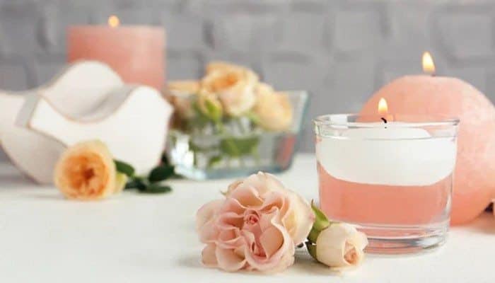 Can You Reuse the Pearls - Fashion In Beauty - Fashion in Beauty Foton Pearled Candle-inspired decor featuring a glowing candle in a clear glass vessel, surrounded by soft pink roses and coordinating candles for an elegant home centerpiece.