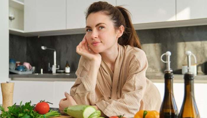 Get Enough Sleep and Avoid Smoking - Fashion In Beauty - Fashion in Beauty How to Make Scabs Heal Faster on Face: Woman sitting near fresh vegetables in a kitchen, highlighting healthy eating habits that support skin healing.